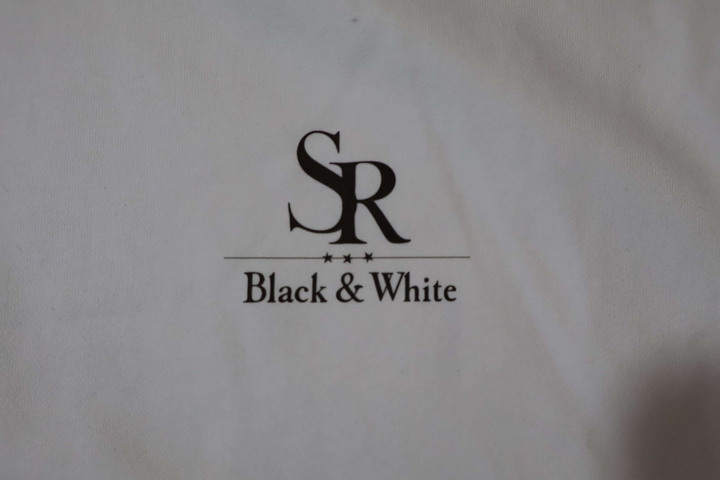 SR Black & White logo on premium hoodie, showcasing minimal style and quality. Perfect for streetwear enthusiasts.