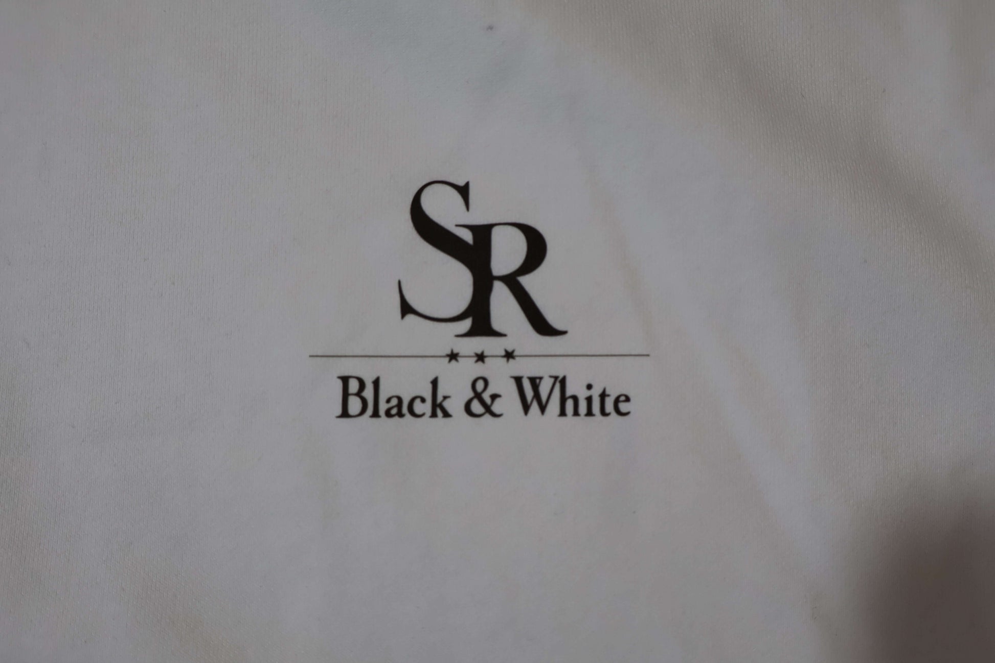 SR Black & White logo on premium hoodie, showcasing minimal style and quality. Perfect for streetwear enthusiasts.