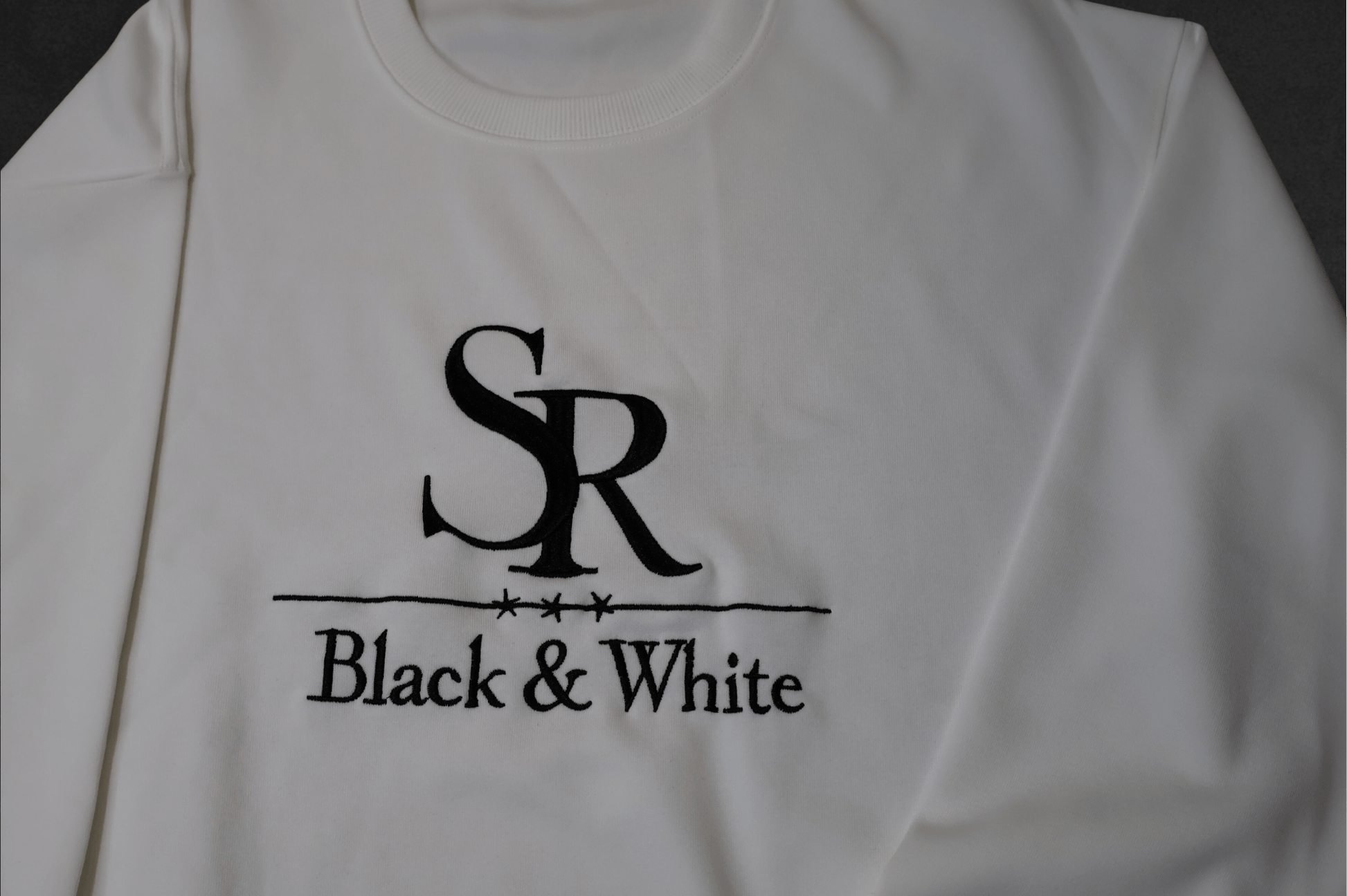 SR Black & White Sweater – Unisex, premium cotton blend, embroidered logo, minimal style, handmade fashion from Studio Romy Black and White.